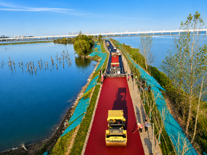 Colored asphalt paving beside a lake, from the supplied hot-mix asphalt brochure